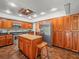 Well-equipped kitchen with wood cabinets, stainless steel appliances, and island at 4118 Carrollwood Village Dr, Tampa, FL 33618