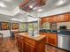 Spacious kitchen with wood cabinets, kitchen island, and views of the pool at 4118 Carrollwood Village Dr, Tampa, FL 33618