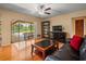 Inviting living room with wood floors, natural light, and a view of the backyard at 4118 Carrollwood Village Dr, Tampa, FL 33618