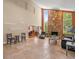 Cozy living room with stone fireplace, travertine flooring, and open to the dining area at 4118 Carrollwood Village Dr, Tampa, FL 33618