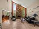 Elegant living room with a stone fireplace, high ceilings, and travertine flooring at 4118 Carrollwood Village Dr, Tampa, FL 33618