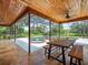 Spacious screened patio with a wood ceiling and dining area overlooking the pool at 4118 Carrollwood Village Dr, Tampa, FL 33618
