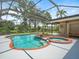 Outdoor pool and hot tub with screened enclosure, landscaping, and sunny, clear skies at 4118 Carrollwood Village Dr, Tampa, FL 33618