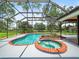 Inviting screened pool and spa area perfect for relaxation and entertaining at 4118 Carrollwood Village Dr, Tampa, FL 33618