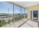 Balcony with white metal railing overlooking a water view and neighborhood greenery at 423 150Th Ave # 1501, Madeira Beach, FL 33708