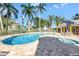 Inviting community pool with lounge chairs and a covered seating area at 423 150Th Ave # 1501, Madeira Beach, FL 33708