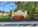 An entrance sign that reads 'Snug Harbour 423-425' surrounded by lush landscaping at 423 150Th Ave # 1501, Madeira Beach, FL 33708