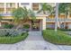 The front entrance features a gray walkway, lush landscaping, and modern touches at 423 150Th Ave # 1501, Madeira Beach, FL 33708