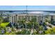 Beautiful condominium building with a shared pool, palm trees, and marina views in a waterfront community at 423 150Th Ave # 1501, Madeira Beach, FL 33708