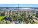 Aerial view of condo complex with pool, palm trees and bay views at 423 150Th Ave # 1501, Madeira Beach, FL 33708