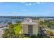 Exterior side view of condo building overlooking a manicured lawn and boat harbor at 423 150Th Ave # 1501, Madeira Beach, FL 33708