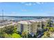 A partial side view of the well-maintained condo building with palm trees and blue skies at 423 150Th Ave # 1501, Madeira Beach, FL 33708