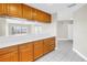 Open kitchen with light-colored countertops and wood cabinetry offers seamless flow at 423 150Th Ave # 1501, Madeira Beach, FL 33708