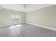 Bright room featuring tile floors, a ceiling fan, and a window offering neighborhood and water views at 423 150Th Ave # 1501, Madeira Beach, FL 33708