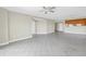 Open living space with tile floors that leads to a modern eat-in kitchen, ceiling fan and neutral paint at 423 150Th Ave # 1501, Madeira Beach, FL 33708