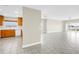 Open living room connected to kitchen area featuring hardwood cabinets and granite countertops at 423 150Th Ave # 1501, Madeira Beach, FL 33708