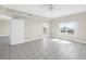 Living space with tile floors, ceiling fan, balcony access and a doorway to an additional space at 423 150Th Ave # 1501, Madeira Beach, FL 33708