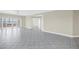 Bright living room with tile flooring, ample space, and a balcony overlooking the water at 423 150Th Ave # 1501, Madeira Beach, FL 33708