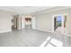 Open living space with tile floors and a glass door to a balcony overlooking neighborhood and water views at 423 150Th Ave # 1501, Madeira Beach, FL 33708