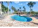 Inviting kidney bean pool area features lounge chairs, a spa, and a shaded pavilion for relaxing by the water at 423 150Th Ave # 1501, Madeira Beach, FL 33708