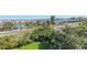 Beautiful view of the bay featuring lush greenery and palm trees along the roadway at 423 150Th Ave # 1501, Madeira Beach, FL 33708