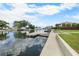 Serene backyard view with boat dock, lush greenery, and canal access at 4279 Newport Dr, Hernando Beach, FL 34607
