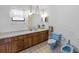 Bathroom with an extended vanity, a mirror with hanging lights, and a light blue toilet and bidet at 4279 Newport Dr, Hernando Beach, FL 34607