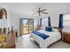 Bright bedroom with a ceiling fan, a full bed, and a sliding glass door to the balcony at 4279 Newport Dr, Hernando Beach, FL 34607