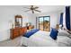 Bright bedroom with a ceiling fan, a full bed, and a sliding glass door to the balcony at 4279 Newport Dr, Hernando Beach, FL 34607