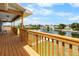 Spacious wooden deck with railing overlooks a canal and surrounding neighborhood at 4279 Newport Dr, Hernando Beach, FL 34607