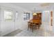 Airy dining room with tile floor and features a decorative light fixture and traditional wooden hutch at 4279 Newport Dr, Hernando Beach, FL 34607