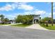 Inviting home exterior featuring a carport, tropical landscaping, and a well-maintained lawn at 4279 Newport Dr, Hernando Beach, FL 34607