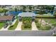 Two-story waterfront home with a convenient two-car covered parking and lush landscaping at 4279 Newport Dr, Hernando Beach, FL 34607
