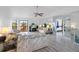 Inviting living room with sliding glass doors to the elevated deck, mirrored walls, and view into bedroom at 4279 Newport Dr, Hernando Beach, FL 34607