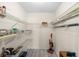 Organized pantry featuring multiple wire racks and a gray wood floor at 4279 Newport Dr, Hernando Beach, FL 34607