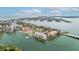 Panoramic aerial showcases waterfront condos with marina amidst vibrant coastal community at 450 Treasure Isle Causeway # 411, Treasure Island, FL 33706