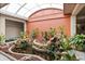 Picturesque atrium with lush greenery, water feature, and koi pond at 450 Treasure Isle Causeway # 411, Treasure Island, FL 33706