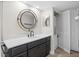 Well-lit bathroom that includes a large vanity, mirror, and laundry closet at 450 Treasure Isle Causeway # 411, Treasure Island, FL 33706