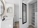 Bright bathroom featuring a floating vanity, modern fixtures, and an open closet at 450 Treasure Isle Causeway # 411, Treasure Island, FL 33706