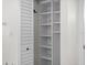 Walk-in closet featuring white shelving and louvered doors at 450 Treasure Isle Causeway # 411, Treasure Island, FL 33706