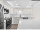 Updated kitchen featuring stainless steel appliances, white cabinetry, and tile backsplash at 450 Treasure Isle Causeway # 411, Treasure Island, FL 33706