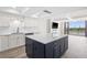Bright kitchen with white cabinetry, quartz countertops, and a large center island with seating at 450 Treasure Isle Causeway # 411, Treasure Island, FL 33706