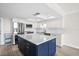 Updated kitchen with white cabinetry, quartz countertops, stainless appliances and blue kitchen island at 450 Treasure Isle Causeway # 411, Treasure Island, FL 33706