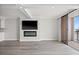 Bright living room featuring a modern fireplace, mounted TV, and sliding glass doors to the balcony at 450 Treasure Isle Causeway # 411, Treasure Island, FL 33706