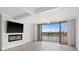 Spacious living room with water views, a modern fireplace, and sliding glass doors to balcony at 450 Treasure Isle Causeway # 411, Treasure Island, FL 33706