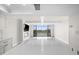Bright and airy living room with water views, neutral walls, and light wood flooring at 450 Treasure Isle Causeway # 411, Treasure Island, FL 33706