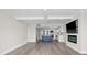 Open-concept living space with an island, stainless steel appliances, electric fireplace, and luxury vinyl plank flooring at 450 Treasure Isle Causeway # 411, Treasure Island, FL 33706