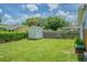 Spacious backyard with a shed and green lawn, providing plenty of room for outdoor activities at 4518 Ashmore Dr, Tampa, FL 33610