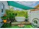 Private backyard oasis featuring a soaking tub with a privacy wall covered in lush climbing plants at 4518 Ashmore Dr, Tampa, FL 33610