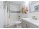 Updated bathroom with tiled shower-tub, modern vanity, decorative mirror and fixtures, and stylish accent decor at 4518 Ashmore Dr, Tampa, FL 33610